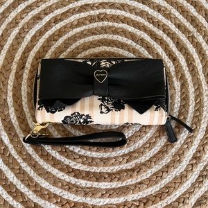 Betsey Johnson wallet wristlet.  Huge bow on the front and a rose pattern.